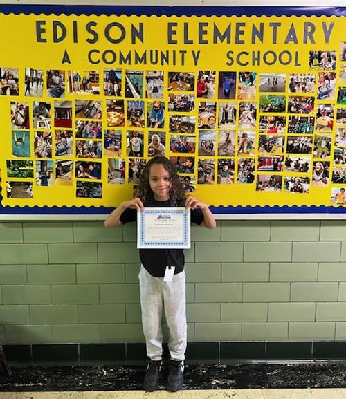 Christopher Kirkland, Edison's October Stairclimber, poses with his certificate.